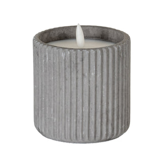 Large grey ribbed LED candle in a round pot, showing the white wax surface and plastic flame.