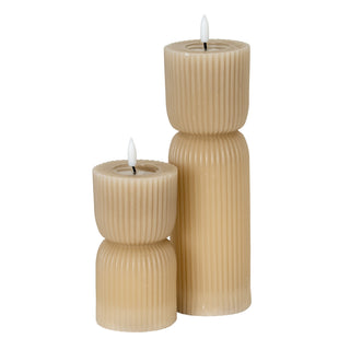 Two fluted, natural stone effect LED candles of different heights displayed together.