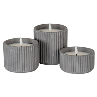 Group of three ribbed grey LED candles in small, medium, and large sizes.