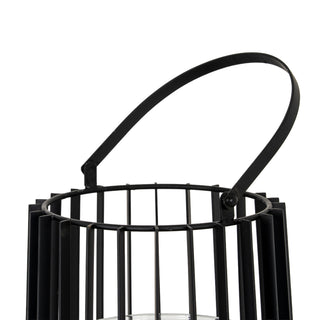 Close-up showing the wide, flat black metal handle hinged connection to the lantern's vertical bar frame.