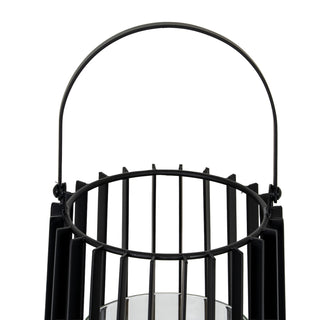 Close-up of the black metal handle and the top edge of the lantern's vertical slat design.