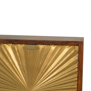 Close-up detail of the dark wood frame, textured gold sunburst drawer front, and small brass tab handle.
