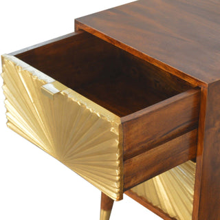 Angled view of the top drawer pulled open, showing the dark wood interior and the gold sunburst front.
