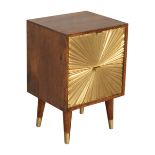 Dark wood bedside cabinet shown from an angle, detailing the textured gold drawers and brass-capped legs.