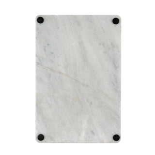 Underside of the rectangular marble board showing the four black protective feet.