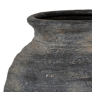 Close-up showing the rough, textured surface of the dark grey vase body and flared neck.