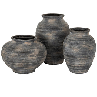 The squat vase displayed alongside two taller, similarly textured vases from the collection.