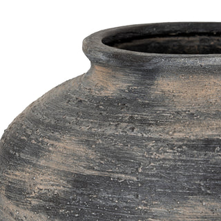 Close detail of the vase shoulder showing rough horizontal striations and distressed finish revealing light tan colour underneath.