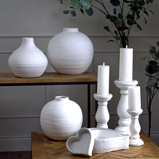 Matt white heart dish displayed in a styled setting, showing the thick, rough, textured sides.