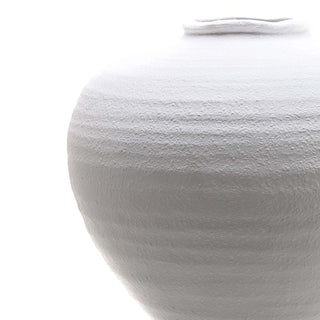 Close detail of the vase shoulder and neck, showing the heavily textured, uneven ceramic finish.
