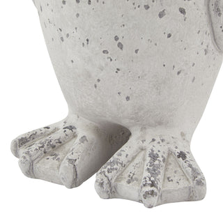 Close detail of the penguin statue's webbed feet showing the mottled grey stone effect finish.