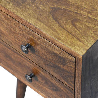 Close-up of the two drawers, dark metal knobs, and the textured chestnut wood top panel.