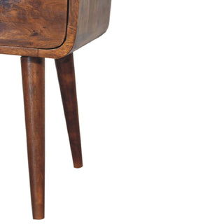 Detail of the tapered chestnut legs and the curved bottom corner of the bedside table body.