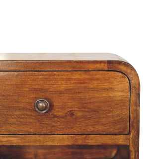 Close-up detail of the curved top corner, wood grain, and antique bronze drawer knob.