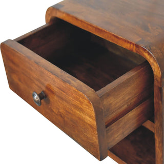 Close-up of the dark wood bedside unit with the storage drawer pulled open, showing the internal construction.