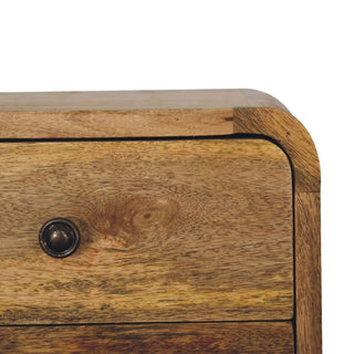 Close detail of the dark metal handle on the oak-ish drawer front, highlighting the rounded top corner joint.