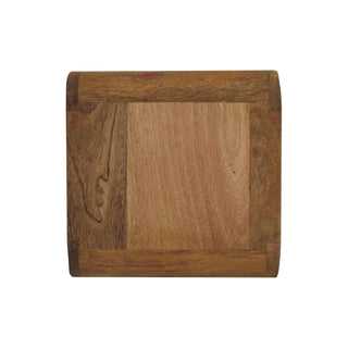Top-down view of the oak-ish bedside cabinet surface, showing the framed panel construction and rounded corners.
