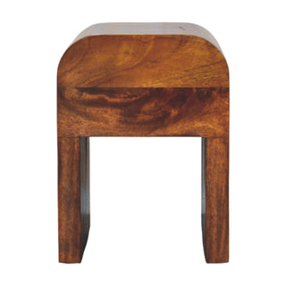 Rear view of the Mini Darcy chestnut nightstand, showing the curved top and supporting legs.