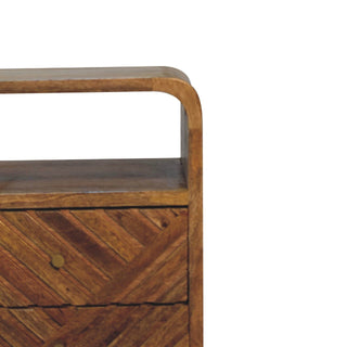 Detail of the curved wooden top rail and open cubby, showing the textured wood grain and brass drawer knob.