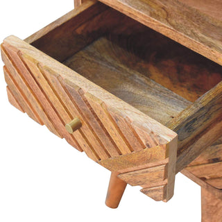 Detail shot of the open drawer, revealing the interior wood grain and diagonally carved front.
