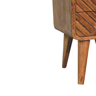 Detail of the tapered legs and the lower curved corner of the wooden cabinet.