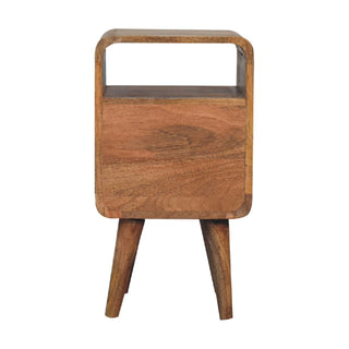 Full front view of the curved wooden bedside table showing the open cubby, solid drawer front, and two tapered legs.