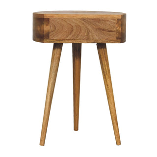 Circular oak-ish bedside table with a curved body and three long, angled, tapered wooden legs.