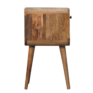 Left side profile of the oak-ish bedside table, showing the depth, rounded corners, and tapered wooden legs.