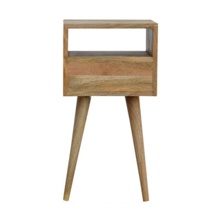 Light wood bedside table with mid-century modern tapered legs, open storage cubby, and drawer.