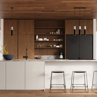 Single and triple Borgio pendant lamps hanging over a kitchen counter and island in a modern wood-panelled room.