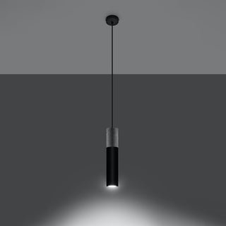 Two-tone cylindrical pendant lamp illuminated, showing the focused downward beam of light.
