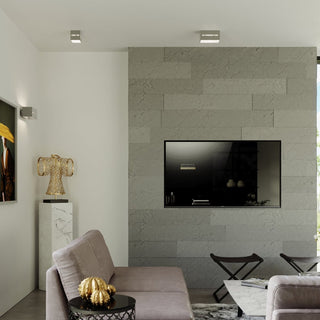 Two grey lamps used as ceiling spotlights in a contemporary living room setting.