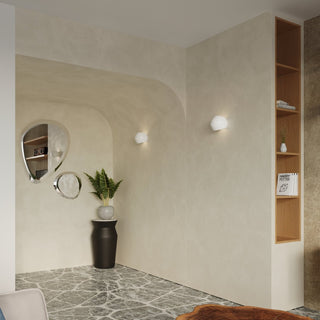 Pair of globe wall lights installed in a contemporary corner setting with arched walls and wooden shelving.