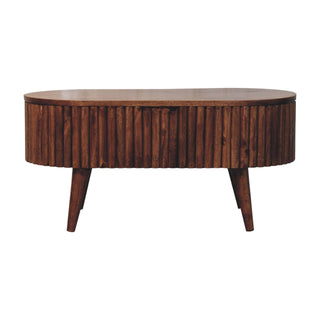 Plain front-on view of the oval coffee table with ribbed wood sides and angled tapered legs.