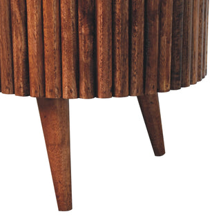 Close-up detail of the ribbed wooden body meeting the angled tapered legs.