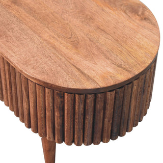 Detail shot highlighting the natural wood grain of the tabletop and the deep texture of the ribbed body.