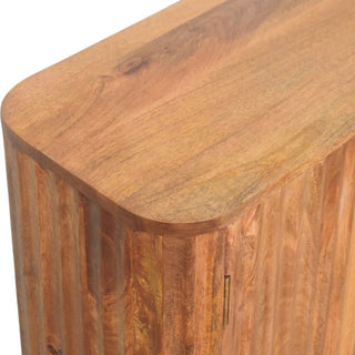 Close-up detail of the reeded wooden side panel and rounded top edge, showing a small brass hinge.