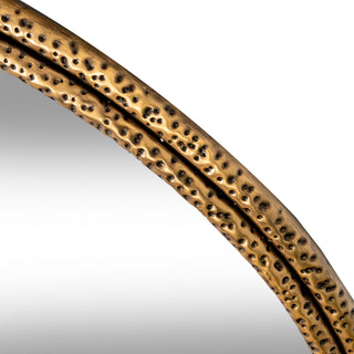 Extreme close-up of the antique gold frame showing the double-banded profile and dimpled surface.