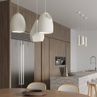 Modern kitchen scene with three cylindrical white pendants over a marble island and wood cabinetry.