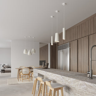 Cylindrical pendant light mixed with other ceramic shapes above a modern kitchen island.