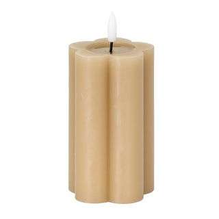 Stone coloured LED candle with a scalloped edge design and white faux flame on a white background.