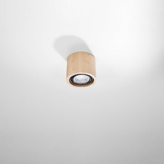 Natural wood ceiling light fixture viewed from below, showing its shadow on the white ceiling.