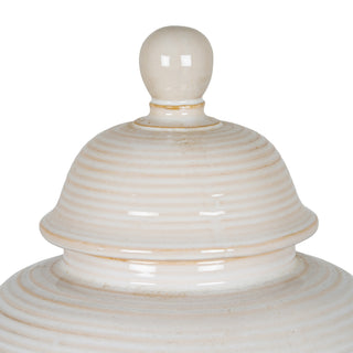Detail shot of the ribbed cream ceramic lid and spherical finial of the ginger jar.