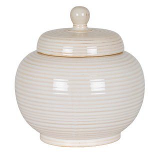 Plain front-on view of the small ceramic jar with a lid, glazed cream, featuring concentric horizontal ribbed texture.