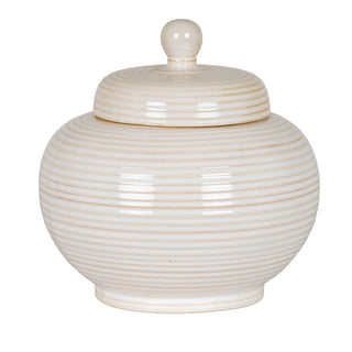 Front view of the large pale ceramic lidded jar. It has a glossy glaze and fine horizontal ridging.