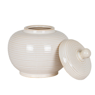 Small cream ceramic jar with horizontal ribbing, shown with its lid resting against the side.