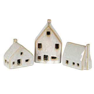 Three ceramic house decorations of varying sizes and shapes displayed as a collection.