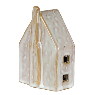Close view showing the glossy, uneven white glaze dripping over the golden ceramic body.