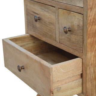 Close view of the bedside cabinet showing the bottom drawer pulled open, revealing the internal wooden construction.