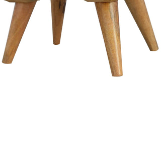 Close view of the four tapered wooden legs of the bedside cabinet.